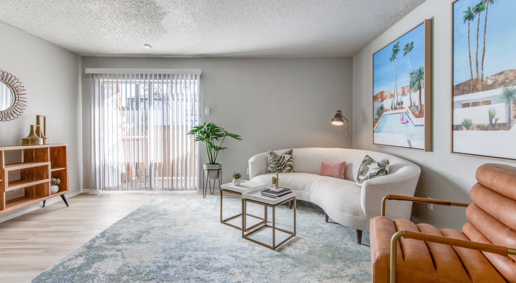 a living room with a couch, coffee table and a painting at The 8500 Harwood