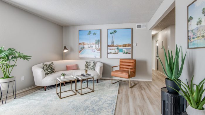 a living room with a couch, coffee table and plants at The 8500 Harwood