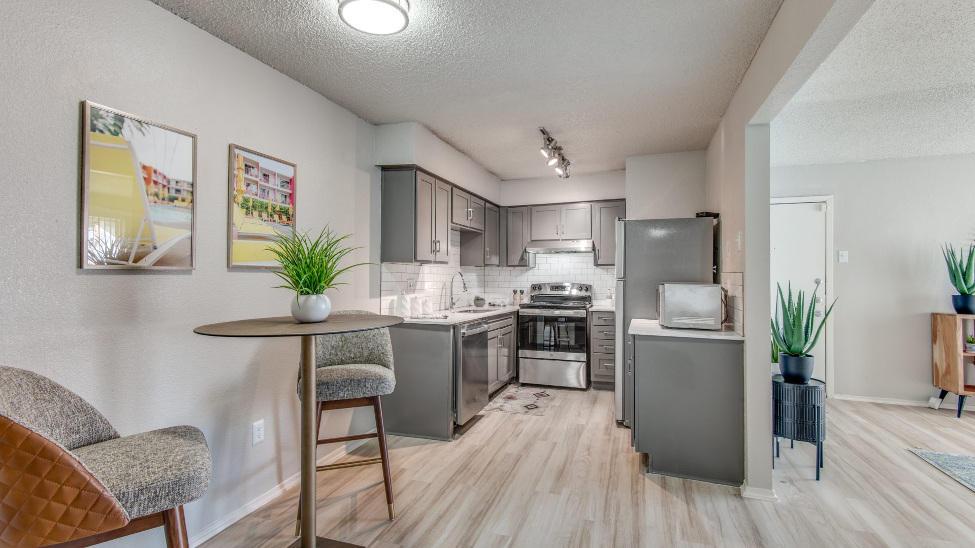 a kitchen and living room with hardwood floors at The 8500 Harwood